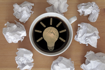 Light bulb symbol inside a coffee cup symbolizing new ideaの写真素材