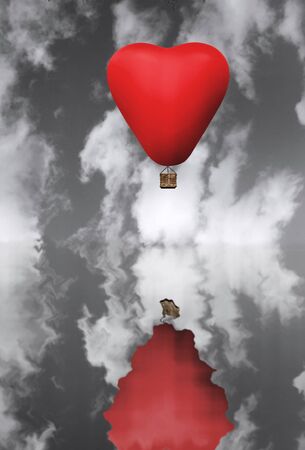 Red hot air balloon in flight against a black and white skyの写真素材