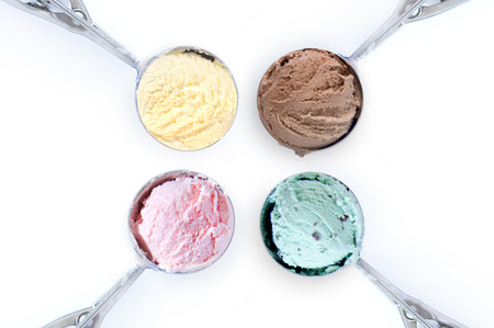 Four flavored ice cream scoops over a white background