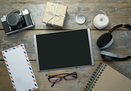 Blank digital tablet with stationery objects, compass and cameraの写真素材