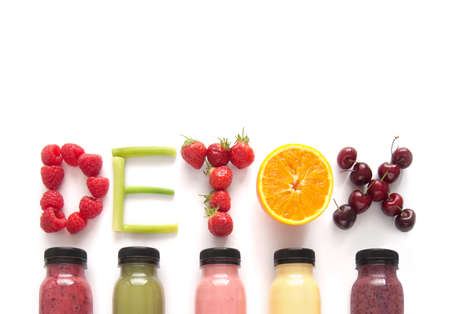 Detox word made with fruits from assorted fruit smoothies over a white backgroundの写真素材