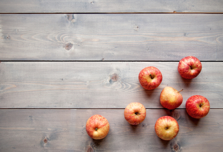 Red apples over a wooden backgroundの写真素材
