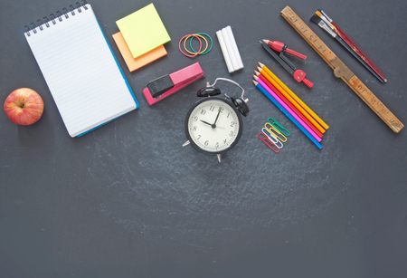 Education stationery accessories on top of a chalkboard with spaceの写真素材