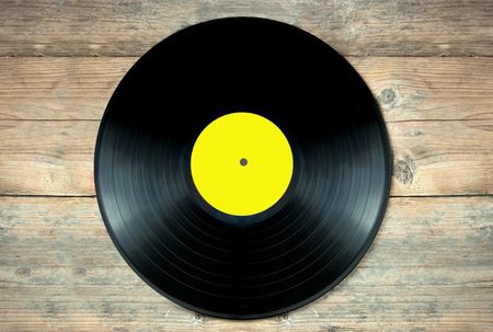 Close up of a vinyl record lp on a wooden tableの写真素材