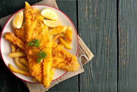 Close up of battered fish on a plate with chipsの写真素材