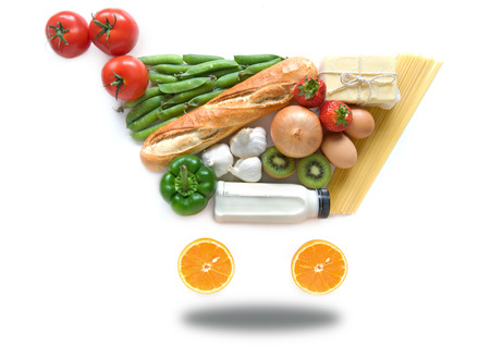 Fruits, vegetables, pasta and dairy products in the shape of a grocery cart icon over a white backgroundの写真素材