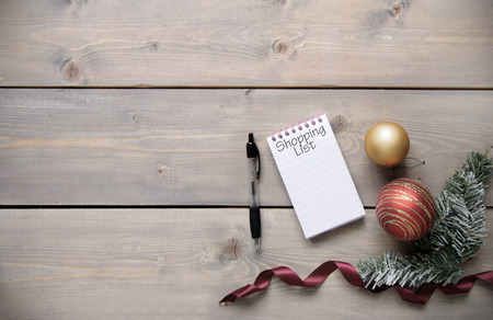 Christmas shopping list over a wooden backgroundの写真素材