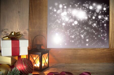 Christmas gifts next to a window with bokeh lights outsideの写真素材