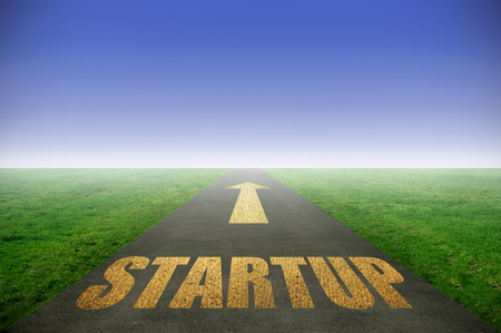 Startup gold printed on road leading towards horizonの写真素材