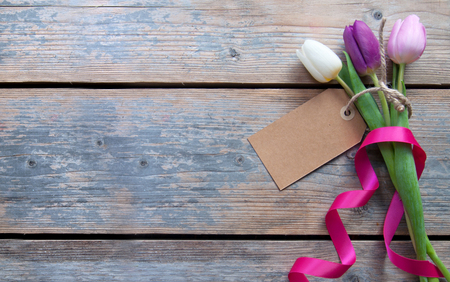 Label attached to spring tulips with decorative ribbonの写真素材