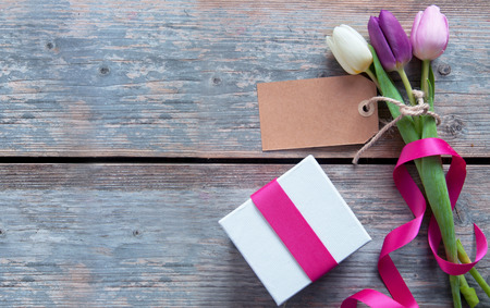 Gift flowers with blank label and decorative ribbonの写真素材