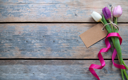 Label attached to spring tulips with decorative ribbonの写真素材