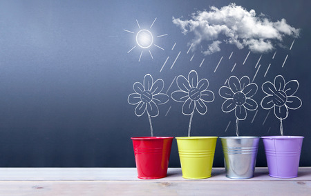 Drawing of spring daisies being on a chalkboard with spaceの写真素材