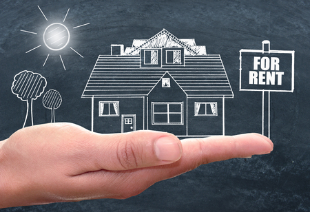 Real estate house for rent chalk board drawing in a handの写真素材