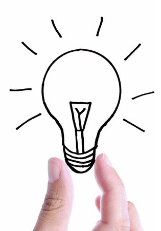 Handing holding a drawing of a light bulb inbetween fingers over a white backgroundの写真素材