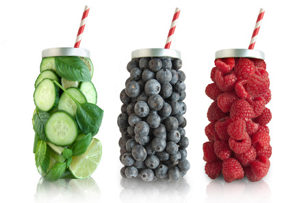 Smoothies in the shape of a beverage with straw including raspberries, blueberries and vegetablesの写真素材