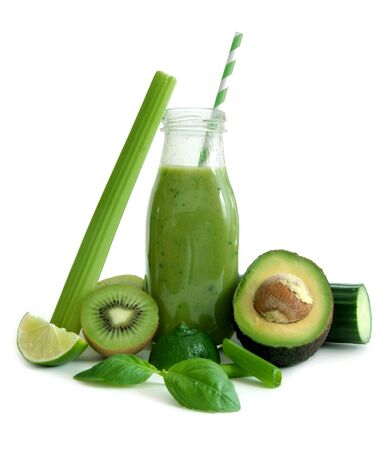 Green smoothie with spinach, avocado and lime over a white backgroundの写真素材
