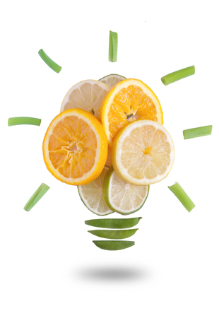Light bulb made of fruits and vegetables over a white backgroundの写真素材