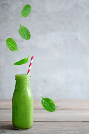 Fresh green smoothie bottle with space for textの写真素材
