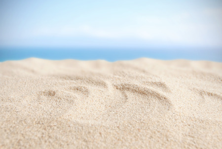Sandy beach with blue sky background