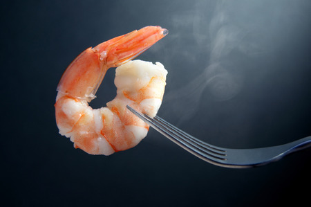 Steaming hot shrimp on a fork closeupの写真素材