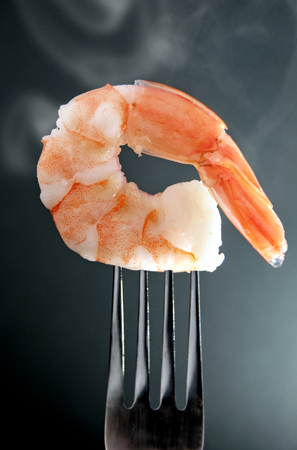 Close up of a cooked shrimp on forkの写真素材