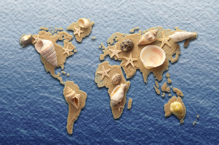 World atlas made from sand and sea shells on a sea backgroundの写真素材