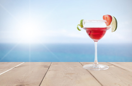 Cocktail beverage with lime and ice by the coastの写真素材