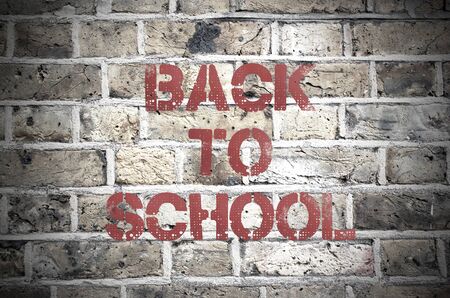 Back to school painted sign on a brick wallの写真素材