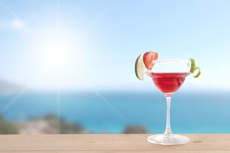 Cocktail beverage with lime and ice by the coastの写真素材