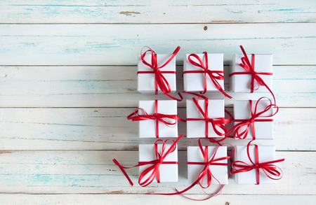 White gift boxes tied with red ribbon with space
