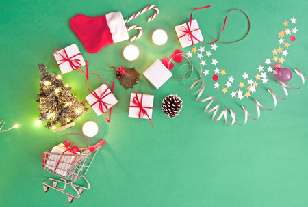 Christmas gifts, baubles, and decorations coming out of a shopping cartの写真素材