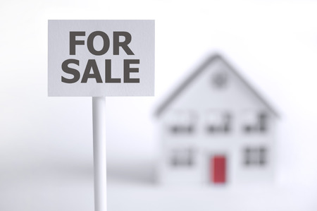 For sale sign in front of a model houseの写真素材