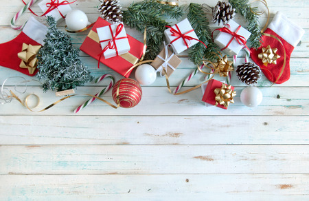 Christmas gifts and decorations over a wooden backgroundの写真素材