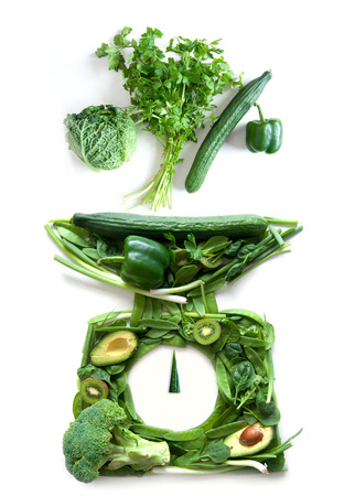 Kitchen weighing scales made of fruits and vegetables の写真素材