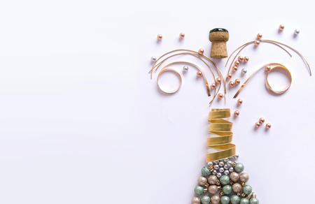 Champagne bottle made from decorations including baubles and ribbonの写真素材
