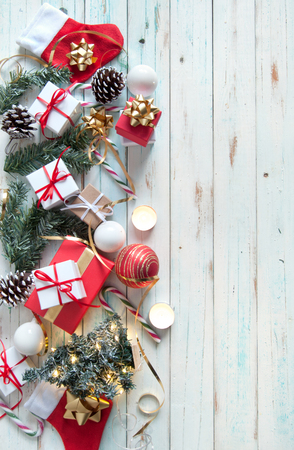 Christmas gifts and decorations with candles on a wooden backgroundの写真素材