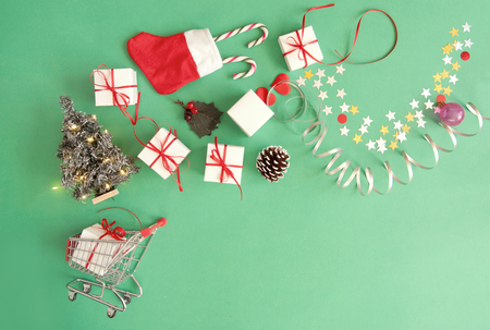 Christmas gifts, baubles, and decorations coming out of a shopping cartの写真素材