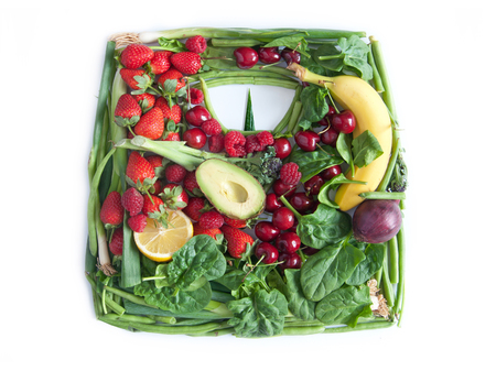 Weighing scales made from fruits and vegetables over a white backgroundの写真素材