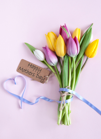 Mothers day tulips with heartshape ribbonの写真素材