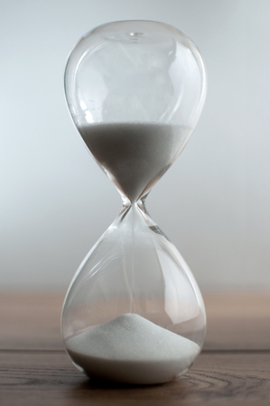 Sand flowing through hourglass closeupの写真素材