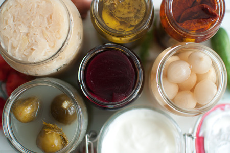 View of open jars with naturally fermented ingredientsの写真素材