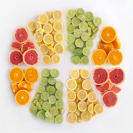Many fruits in the shape of a sliced citrus including oranges, grapefruits, lemons and limesの写真素材