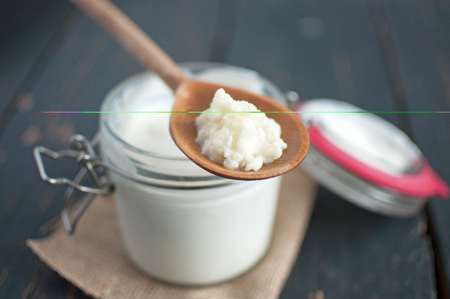 Closeup of kefir seeds on a wooden spoonの写真素材