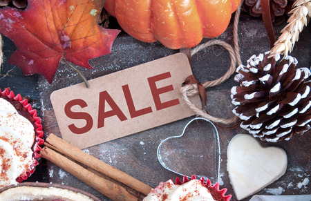 Autumn sale sign greeting card on a wooden cutting boardの写真素材
