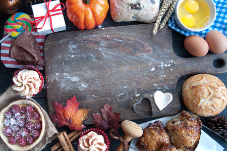 Empty chopping board surrounded by ingredients for a thanksiving meal both savoury and sweetの写真素材