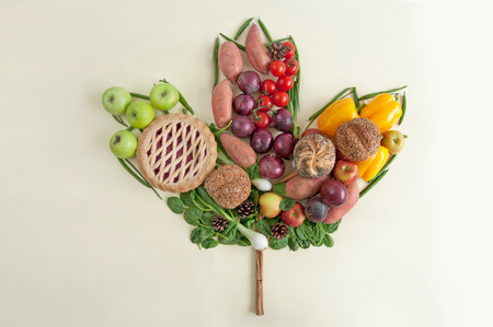Thanksgiving seasonal fruits and vegetables in the shape of an autumn leafの写真素材