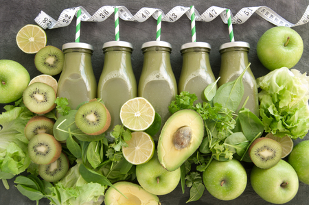 Green bottled smoothies with straws and fresh ingredientsの写真素材