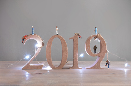 Miniature people climbing 2019 wooden blocksの写真素材