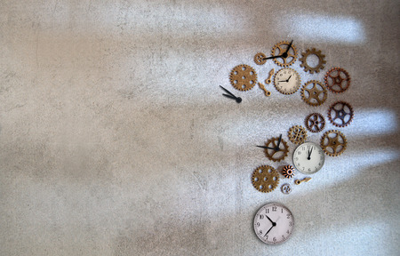 Clock parts including hands gears and cogs in the shape of a question mark on a concrete backgroundの写真素材